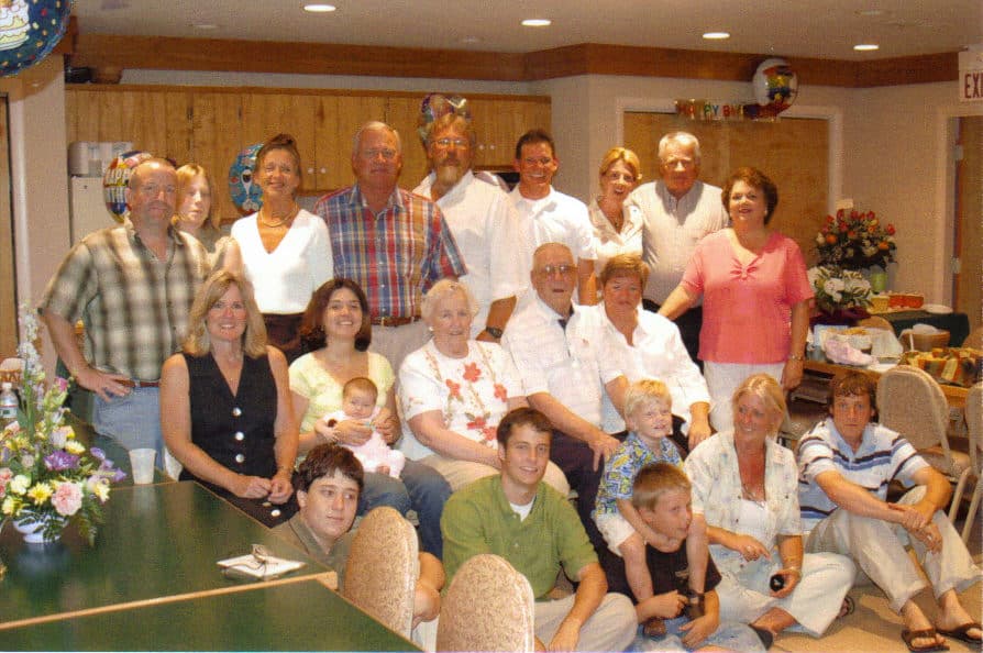 A family gathered in the meeting room at the Refuge Inn for a birthday celebration, four generations together.