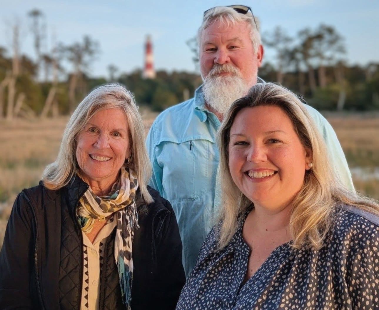 Jane, Arthur, and Cynthia pose for the camera in front of the Assateague Lighthouse.