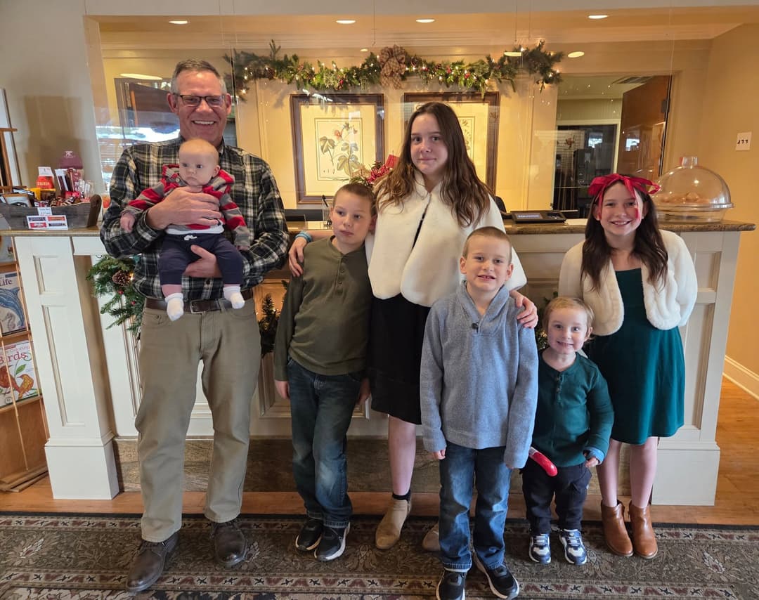 Michael Leonard with his children at the Refuge Inn front desk at Christmas.