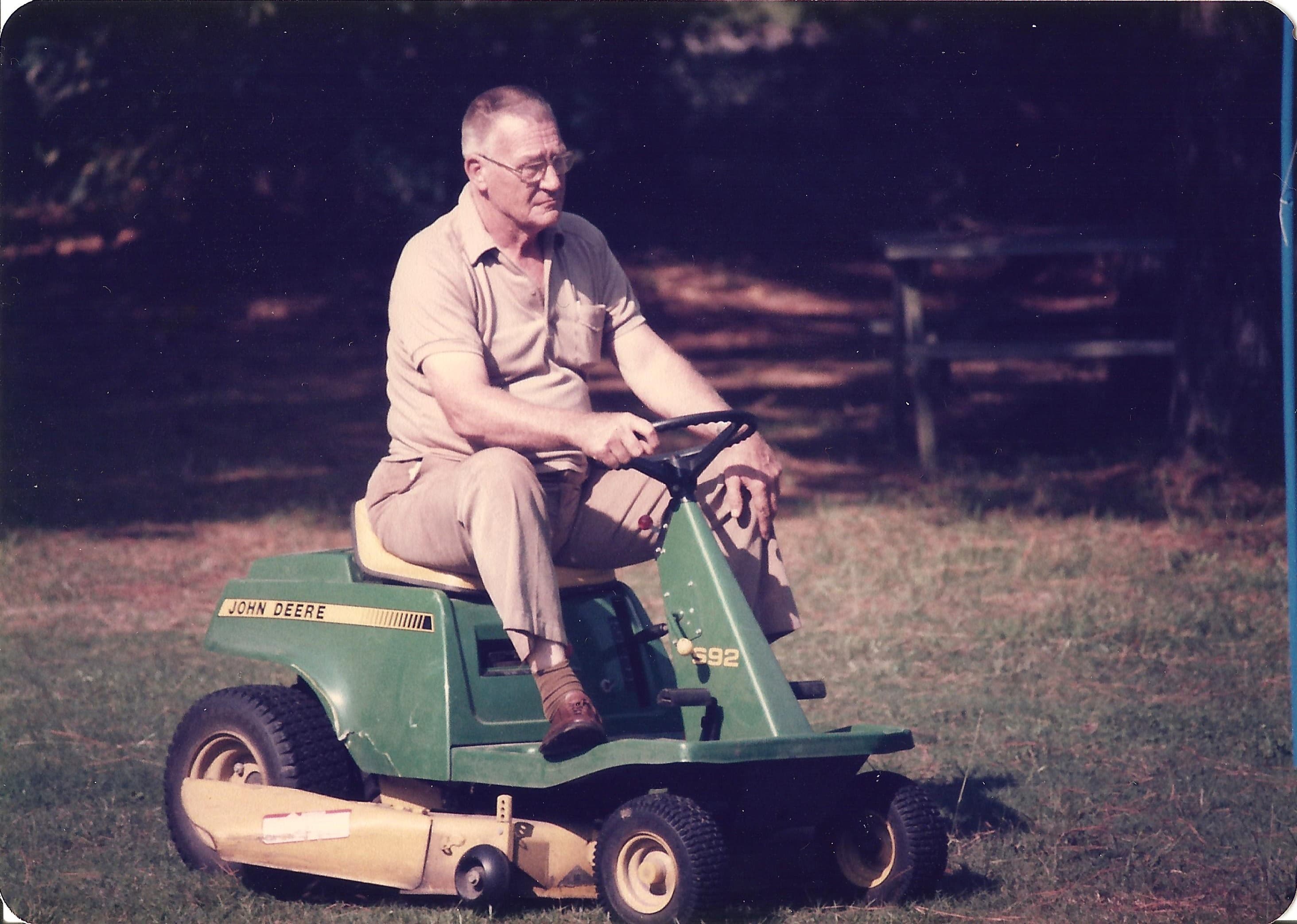 Refuge Inn founder Don Leonard mowing the grounds on his John Deere riding mower.
