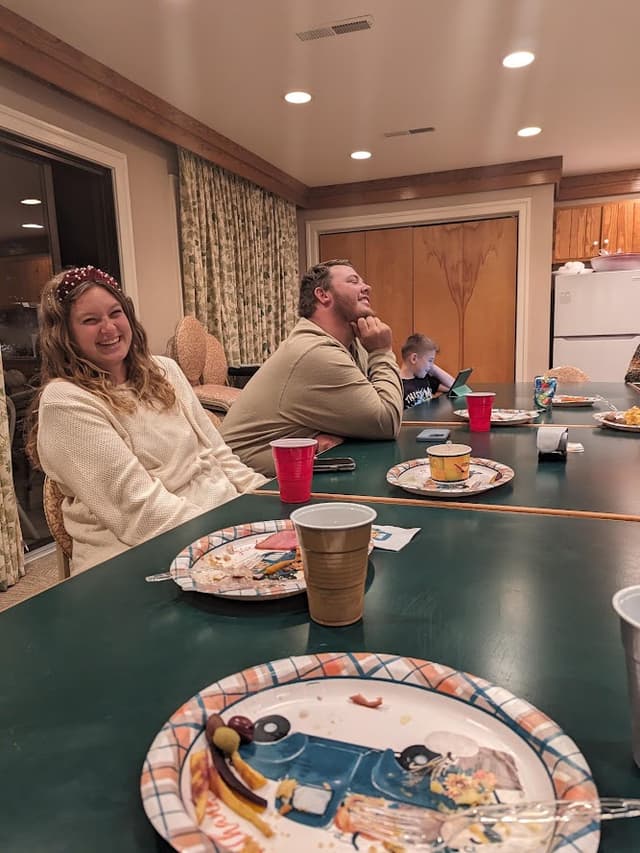 Guests around the table at a family reunion dinner in the Refuge Inn meeting room.