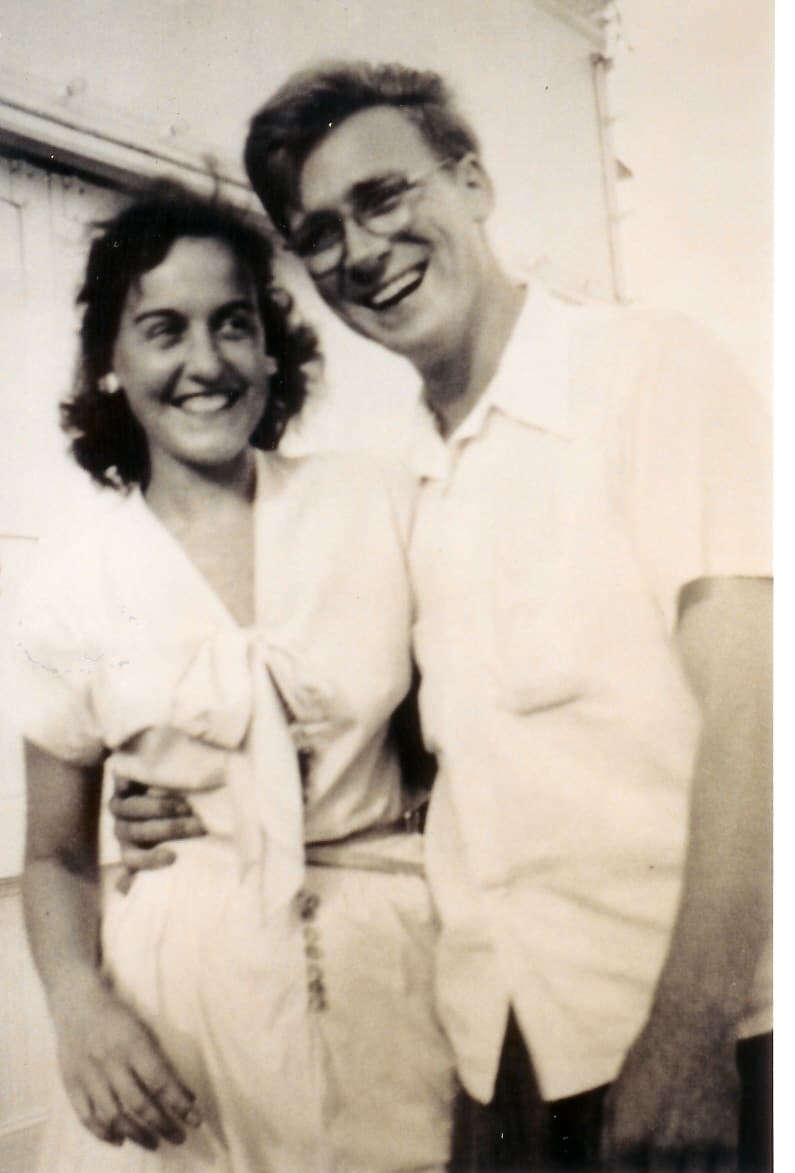 Don and Martha pose for a boardwalk photographer during the early days of their marriage. The black and white photo shows her dressed smartly, smiling widely. Don appears young and carefree, with his arm around her waist.